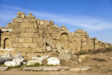 The old ruined walls of the ancient city . Beautiful background with ancient ruins and Sunny summer day.