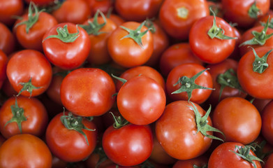 Qualitative background from tomatoes. Fresh tomatoes. Red tomatoes. Village market organic tomatoes.