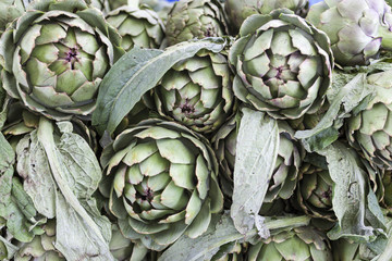 Large fruit of the artichoke. Fresh artichoke at the village market.