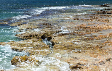 Beautiful view of sea stone beach, sea, waves, blue sky.