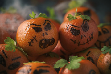 tangerines ornamented as carved pumpkins