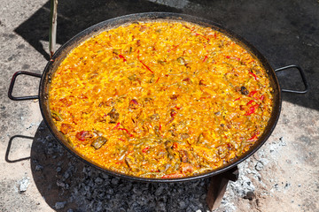 Seafood Paella. The national Spanish dish of paella in a large skillet is cooked on an open fire, at the stake.