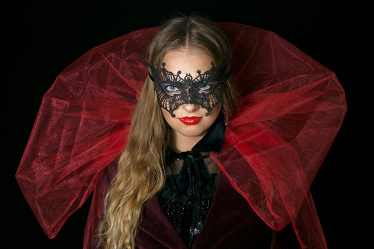 make-up girl witch on halloween costume in black mask.