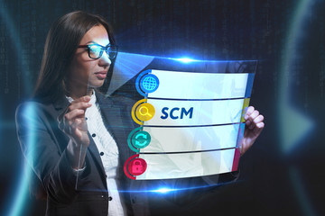 The concept of business, technology, the Internet and the network. A young entrepreneur working on a virtual screen of the future and sees the inscription: SCM