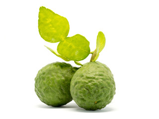 close up group of fresh bergamot with green leaves isolated on white background. benefits of bergamot for beauty and health concept