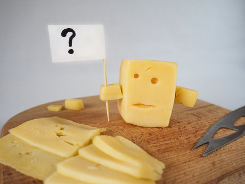 Funny Cheese Resembling A Person Holds With Screen A Question Mark.