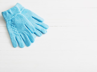 blue gloves on white wooden background