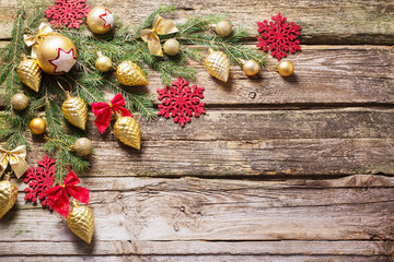 Red and golden christmas decoration on wooden background