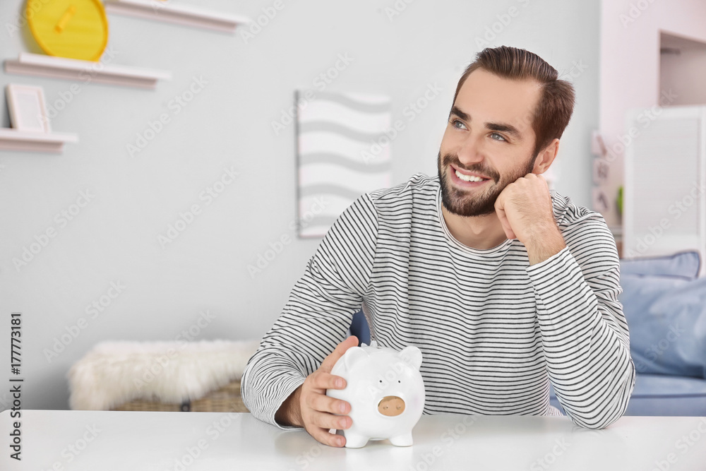 Sticker young man with piggy bank at table