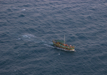 The ship floats in the sea and carries tourists to rest