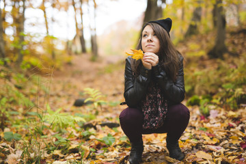 Portrait of cheerful young woman in autumn season