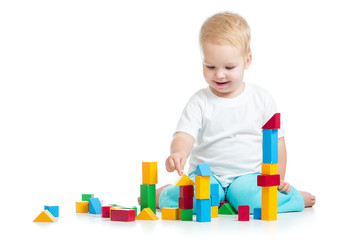 kid girl playing toy blocks isolated on white