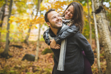 Young couple in love in a park on a autumn day