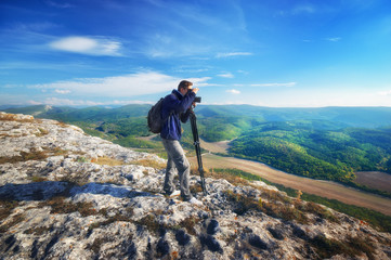 Photographer work in mountain. Job scene.