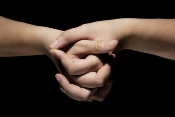 hands in mudra gesture on black background