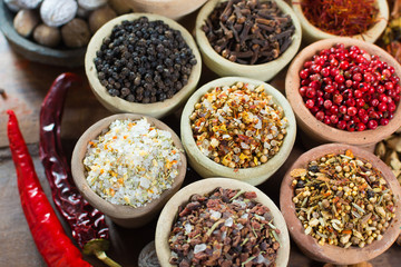 Variety of different asian and middle east spices, colorful assortment, on old wooden table