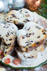 Traditional German Christmas raisins and dried fruits cake with sugar powder and Christmas decorations