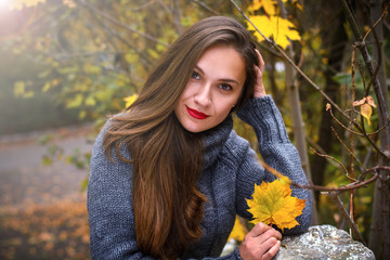 Beautiful girl with long hair in autumn park