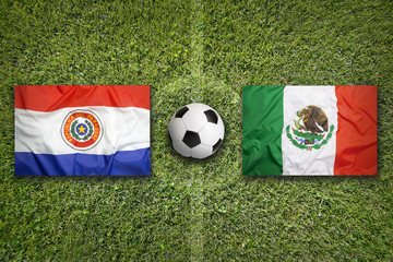 Paraguay vs. Mexico flags on soccer field