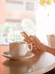 Cup of coffee on the table in coffee shop
