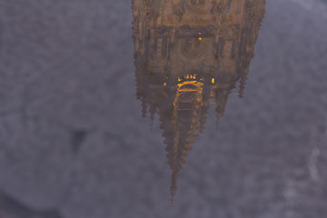 Oviedo cathedral is reflected in a puddle
