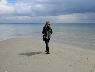 woman walking beach coast