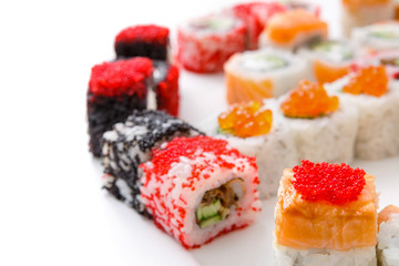 Closeup set of sushi rolls, maki with caviar on white background