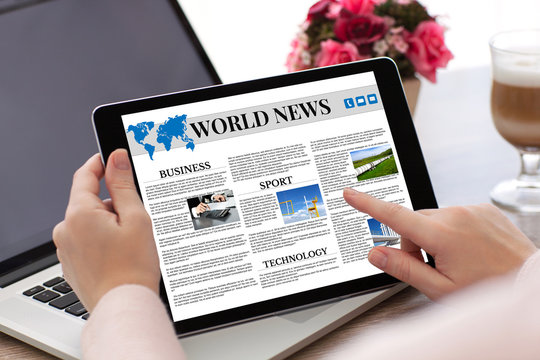 woman hands holding tablet computer  with app world news screen