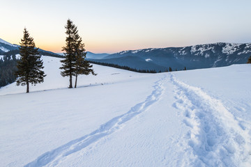 Beautiful winter landscape in the mountains with snow path in steppe
