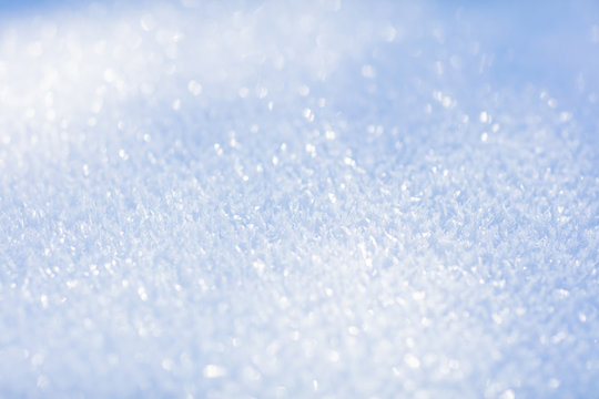 White snow. Sparkling snowflakes. Winter background. Close up.