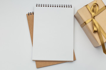 Notebooks with a gift box on a white background