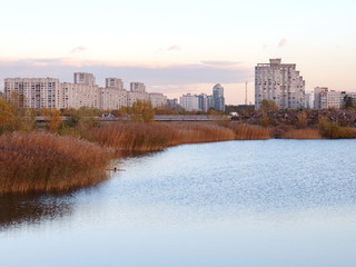 Fototapeta premium Urban blocks high-rise buildings on the beach at sunset