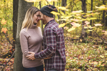 Young couple in love in a park on a autumn day