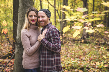 Young couple in love in a park on a autumn day