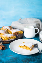 Apple strudel pie. Puff pastry on blue.