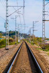 Fototapeta na wymiar Vertical view of the railroad going into the distance in sunny day, Sochi, Russia