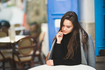 Fashion woman portrait of young pretty trendy girl posing at the city in Europe