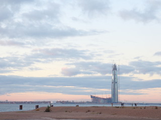 In the evening construction of a skyscraper on the coast
