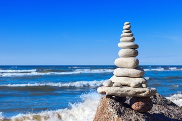 Fototapeta na wymiar Concept of balance and harmony. White rocks zen on the background of sea and blue sky