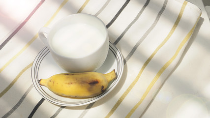 Cold milk and banana fruit breakfast has copy space