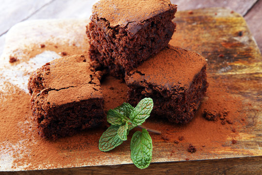 Cake chocolate brownies on wooden background with mint