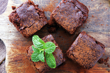 Cake chocolate brownies on wooden background with mint