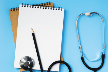 Stethoscope on a blue table, concept of medicine
