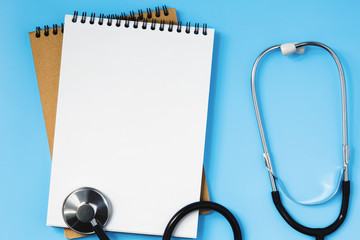 Stethoscope on a blue table, concept of medicine