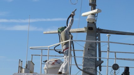 sandblaster at work on ship