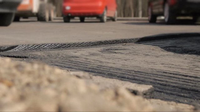 Cars passing through the speed bump on a road