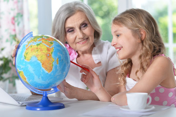 Fototapeta premium grandmother and granddaughter doing homework