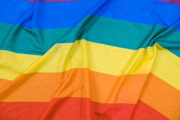 Fabric texture of the Gay flag background. LGBT waving flag
