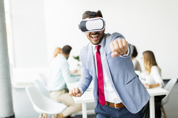 Modern businessman with virtual reality headsets in the office