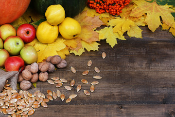 A day of blessing. Pumpkins, apples, nuts, seeds, ah on a wooden background.